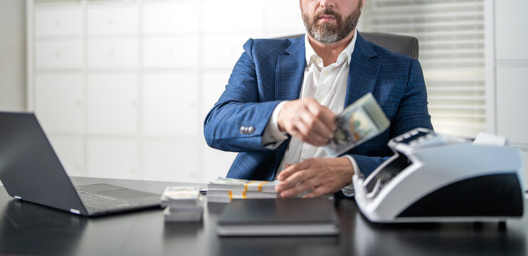Successful entrepreneurship. Banker man with banknote counter. Currency counter. Financial prosperity. Banking and currency management. Male bank manager using cash counting machine in office