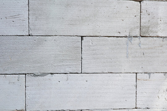 Light gray lightweight concrete block or autoclaved aerated concrete AAC brick wall texture
