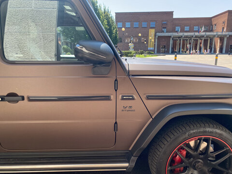 Mercedes Benz AMG G63 SUV in matte brown color parked on Via Giovanni Baldesio, Cremona, Italy