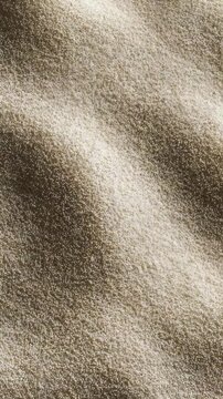 Detailed macro shot of fine sand grains forming smooth, wavy patterns under soft lighting. Ideal for backgrounds, spa concepts, and tranquil nature inspired visuals in modern design
