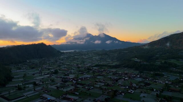 Aerial sunrise reveal of Lake Batur and Mount Abang, Kintamani Bali