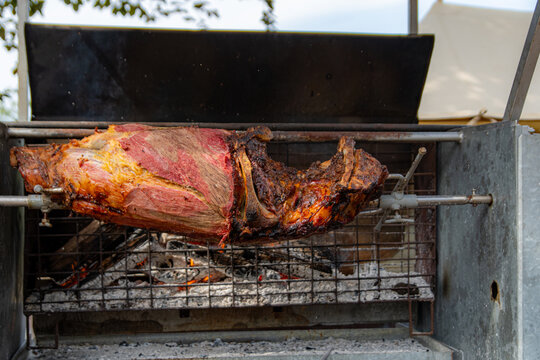 Luscious meat on a pike in front of glowing coal ready to be eaten.