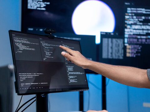 Close up shot show hand software engineer pointing to computer screen, checking for error or inaccurate in the coding Cyber security. Professional programmer work verifying dashboard data development