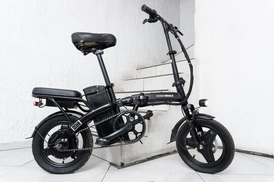 ZAPOPAN, MEXICO - AUGUST 5, 2026: Black Honey Whale S6-S electric bicycle parked by indoor stairs.