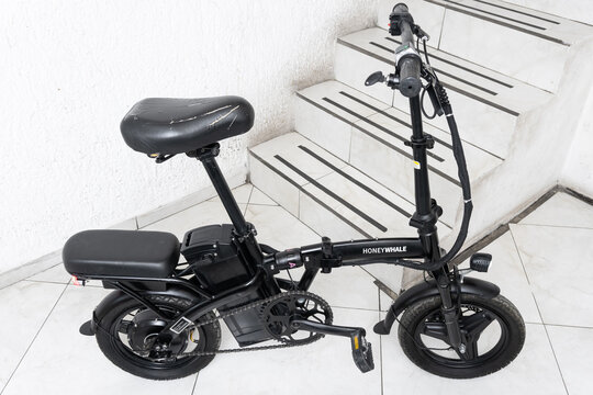 ZAPOPAN, MEXICO - AUGUST 5, 2026: Black Honey Whale S6-S electric bicycle parked by stairs.