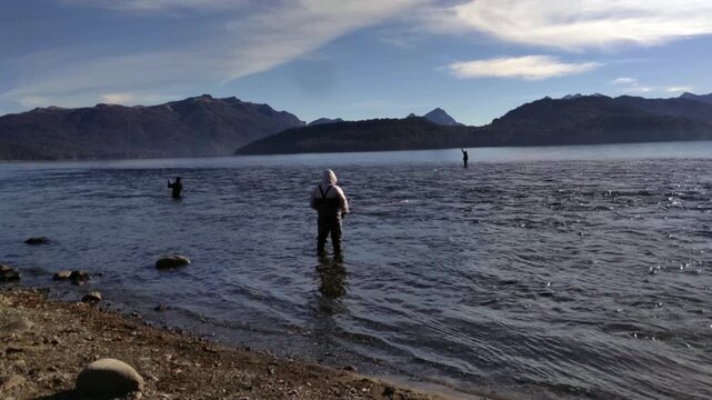 Multiple Fly Fishermen Wading and Casting in Scenic Patagonian Lake