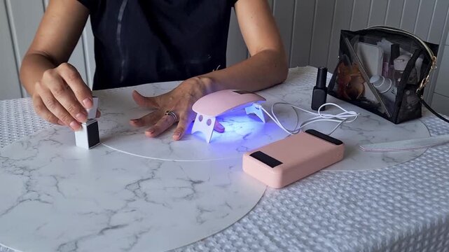 Nail care and design process at home using tools and products on a marble table