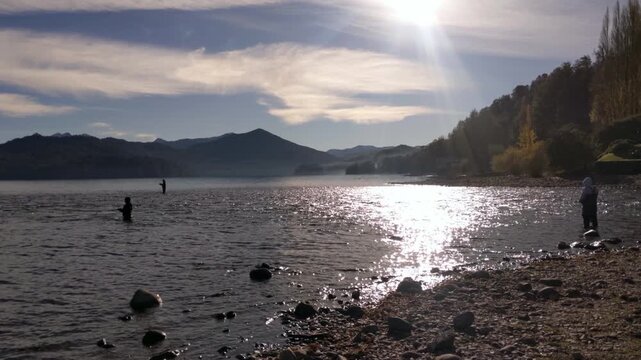 Fly Fishing in Scenic Patagonian Lake with Mountains in the Background