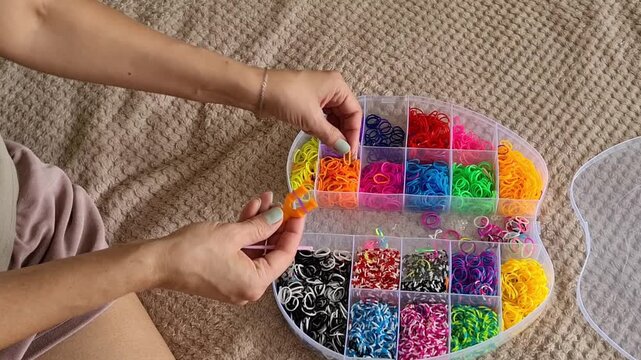 Creating colorful bracelets with rubber bands in a home setting