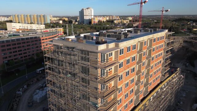 building facade with mineral wool insulation, Drone flight view. wool panels are being fixed to the facade  multi-story residential building undergoing exterior thermal insulation.