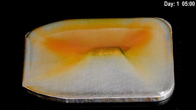 rust forming on an iron plate in water time lapse