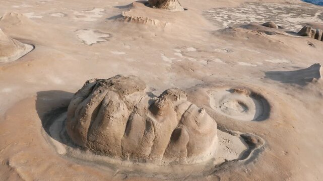 Natural eroded stone looks like human face, Yehliu Geopark. Weathered and washed out soft components from rocky shore, creating fantastic landscape. Camera show close up to one stone on ground