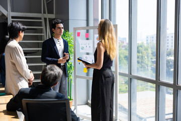 Fototapeta premium Hispanic young male, Company Operations Manager Meeting training and coaching Presentation. Diverse Team with infographics Growth Analysis, Charts, Statistics and Data. People Work in Business Office