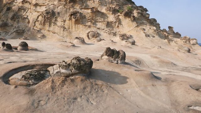 Otherworldly look of sea shore at Yehliu Geological Park, odd stone formation on rocky coast, fantastic landscape. Characteristic mushroom shaped stone can be seen on this rocky place.
