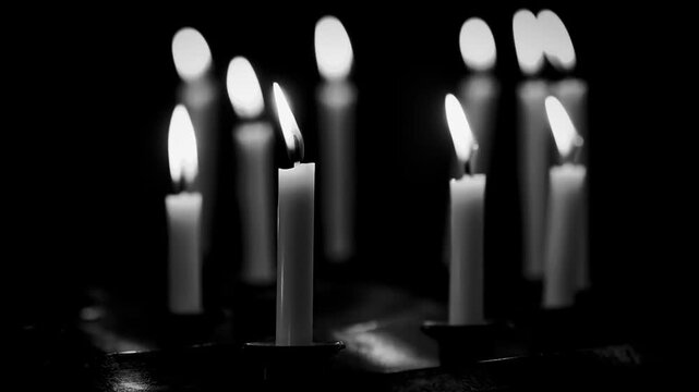 Close-up of lit birthday candles. Celebratory scene with glowing flames and festive mood.