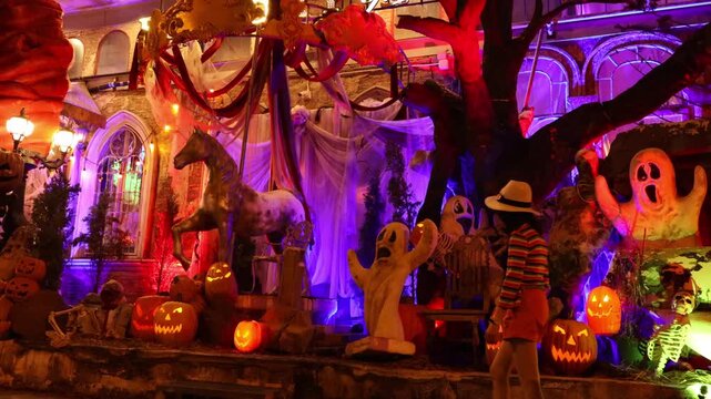 lifestyle footage capturing a female visitor experiencing a beautifully lit Halloween outdoor event