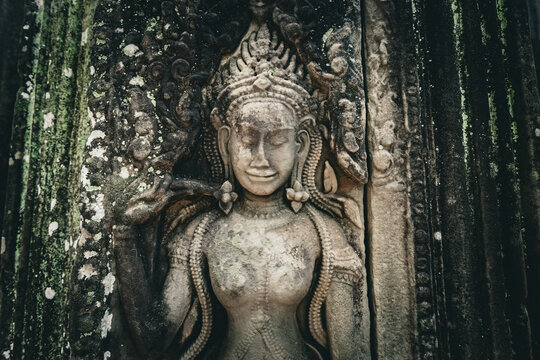 Ancient stone carving of a female Apsara dancer inside Angkor Wat temple in Siem Reap, Cambodia