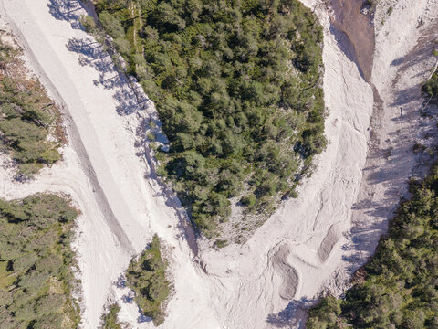 Aerial view of a debris flow path cutting through a mountain forest, showing signs of slope instability and erosion in the Dolomites near Cortina d'Ampezzo, Veneto, Italy.