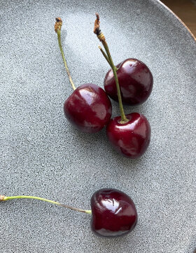 Fresh Sweet Cherries on Textured Gray Background with Copy Space