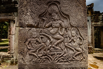 Fototapeta premium Ancient sandstone bas-relief depicting a historical battle and warriors on the walls of Bayon Temple in Angkor Thom, Siem Reap, Cambodia