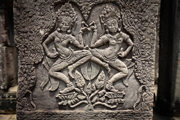 Fototapeta premium Ancient sandstone bas-relief depicting a historical battle and warriors on the walls of Bayon Temple in Angkor Thom, Siem Reap, Cambodia