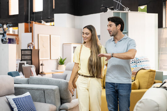 Young couple exploring a furniture store showroom looking for new home decor
