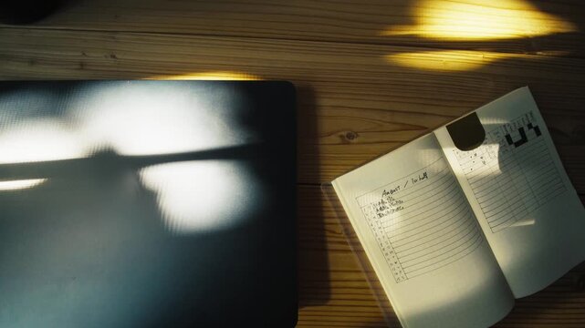 Open Bullet Journal Planner on Desk with Dappled Sunlight 4K