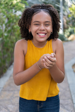 Happy teen girl laughing outdoors, showing joy