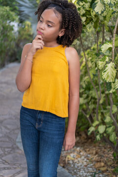 Thoughtful young girl thinking with hand on chin