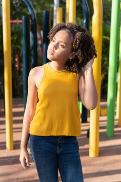 Young girl looking up at the sunshine in a park