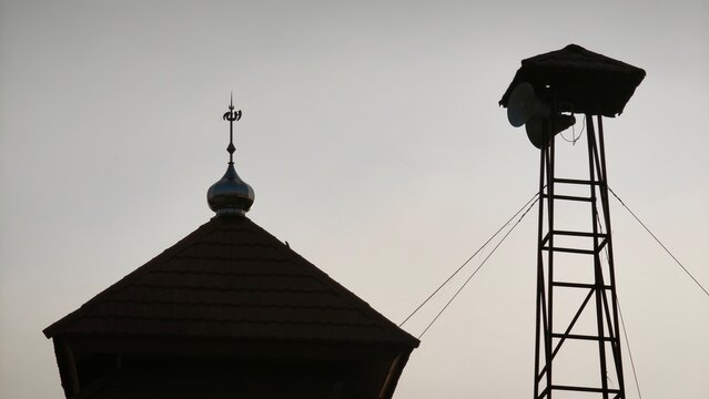 A serene mosque silhouette at sunset with a vibrant yellow sun