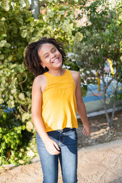 Happy teen girl smiling laughing in park outdoor portrait