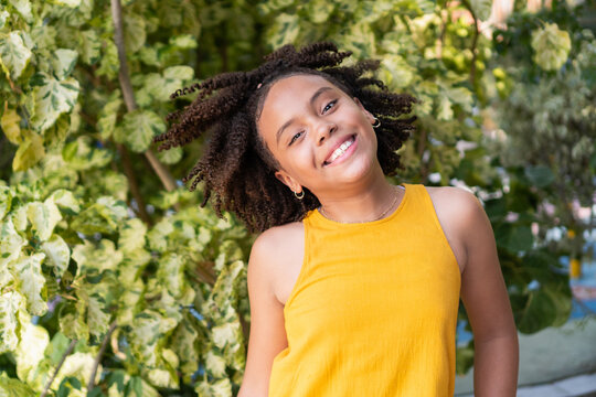 Happy young girl smiling at camera outdoors