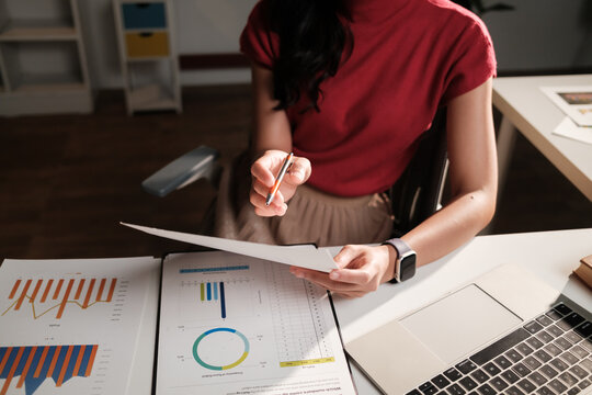 Woman analyzing business data and financial graphs