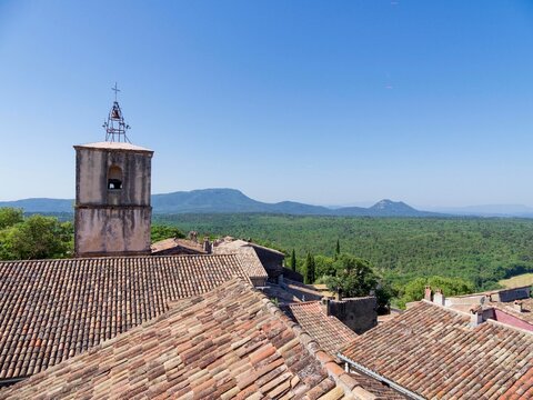 View from he Proven&ccedil;al village of Fox-Amphoux with its bell tower and campanile. Green Var forest at foot of Gros and Petit Bessillon followed by Mont Aurelien in horizon
