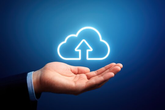 A hand holding a glowing cloud upload icon symbolizing cloud computing and data storage technology.