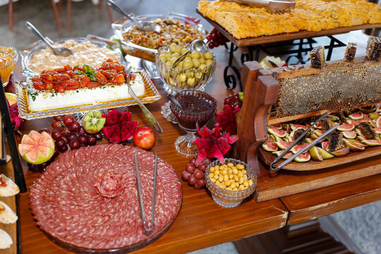 Gourmet Antipasto Table with Sliced Salami Cheeses Cherry Tomatoes Dragon Fruit and Figs