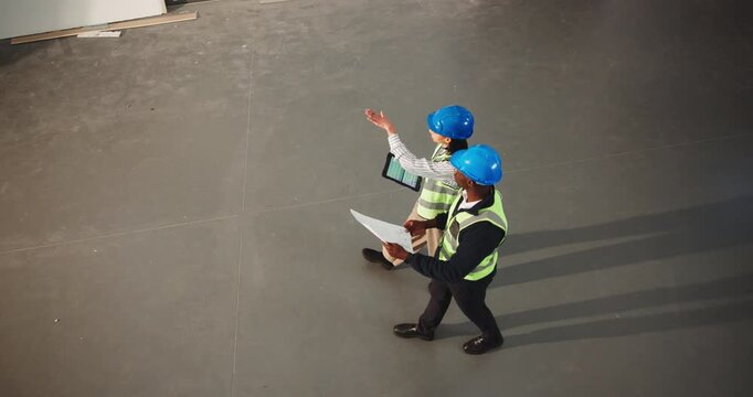 Team, tablet and construction inspection with blueprint for design vision, space layout or above. People, foreman and schematic with tech screen for CAD, remodeling progress and building evaluation