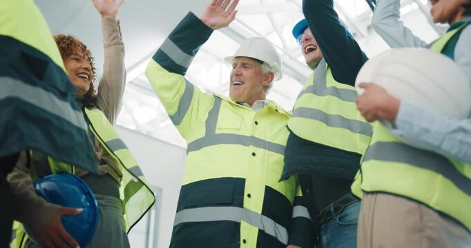 Happy, architect and team with hands together for construction success, mission or achievement. Low angle, people or group of contractors piling with applause, high five or smile for celebration