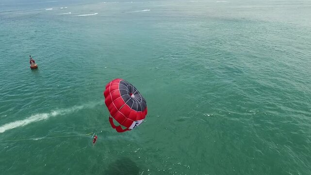 One of the activities offered at Tanjung Benoa in Bali is a parasailing adventure.