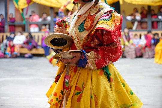 Bhutan, in the village of Bumthang, a monk mask dancer in his colourful costume dances at the festival of Jakar.