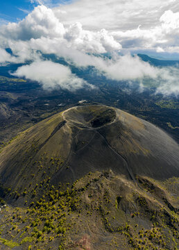 Aerial view of Paricutin Volcano featuring its iconic cinder cone crater surrounded by volcanic landscape and scattered vegetation in Uruapan, Michoacan, Mexico.