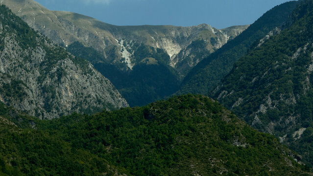 Majestic rocky mountain peaks rising above lush green hills in Gjirokaster region Albania