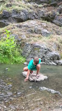 Boy Playing in a Mountain Stream in Divoka Sarka