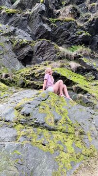 10-year-old girl exploring rocky landscape in Divoka Sarka nature reserve in Prague