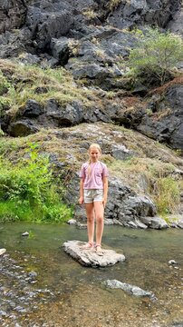 10-year-old girl exploring rocky landscape in Divoka Sarka nature reserve in Prague