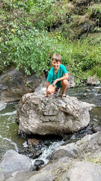 10-year-old boy exploring rocky landscape in Divoka Sarka nature reserve in Prague