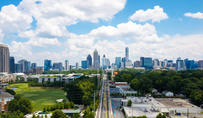 Drone photo of Atlanta skyline with a clear view of 14th street heading straight into the heart of the city.  Great white clouds span the skyline. © Visual Art Complex