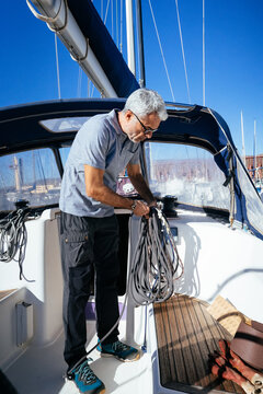 Middle aged man standing on boat in daylight