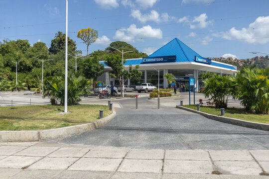 CARACAS, VENEZUELA - JUNE 28, 2026: Exterior View of a Farmatodo Drugstore and Convenience Store with Blue Roof Under Sunny Sky